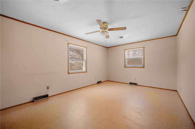 unfurnished room featuring crown molding, ceiling fan, visible vents, and baseboards