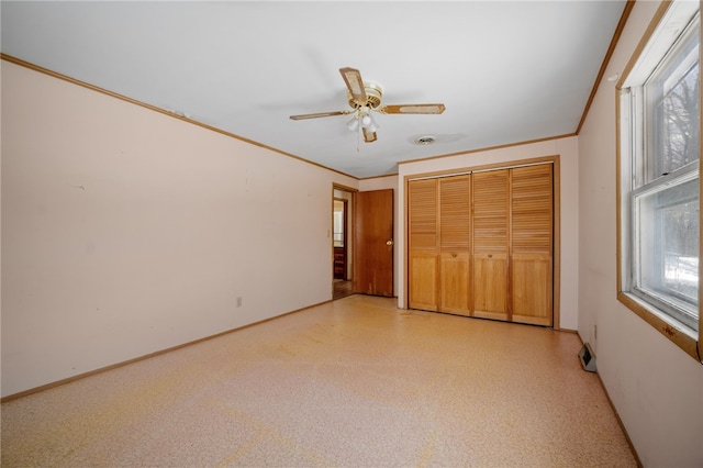 unfurnished bedroom featuring ornamental molding, a closet, multiple windows, and baseboards