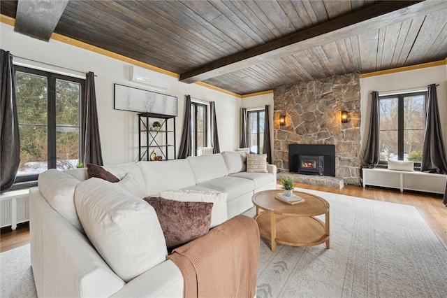 living area featuring light wood-type flooring, wood ceiling, beam ceiling, and radiator heating unit