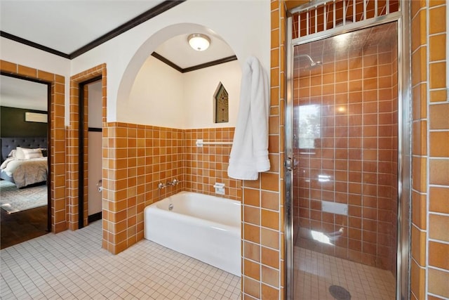 bathroom with a garden tub, crown molding, tile walls, ensuite bathroom, and tile patterned floors