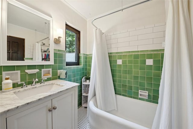 bathroom with crown molding, tile walls, shower / bath combo, wainscoting, and vanity