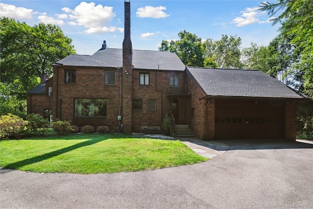 view of front of property with a garage, brick siding, a shingled roof, driveway, and a front yard