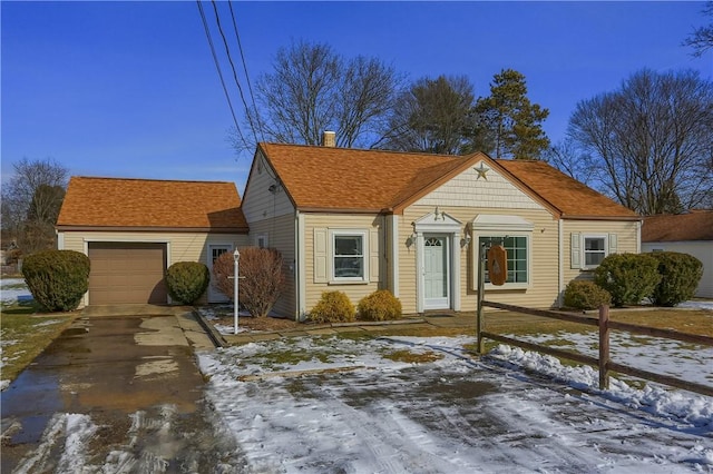 view of front of home with driveway, a chimney, and an attached garage