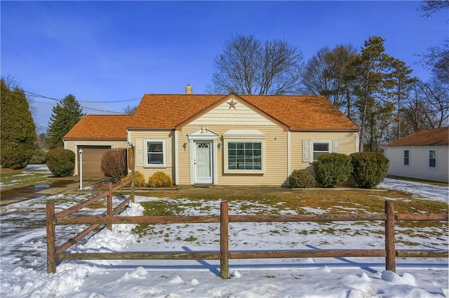 view of front of home with fence and an attached garage