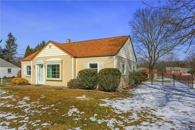 view of front of home featuring fence and a chimney