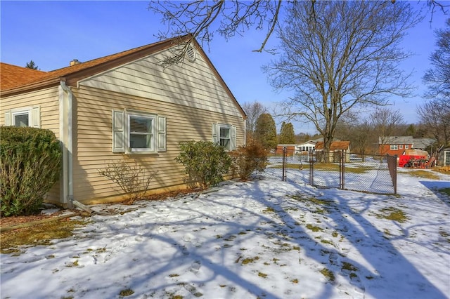 view of snowy exterior featuring fence