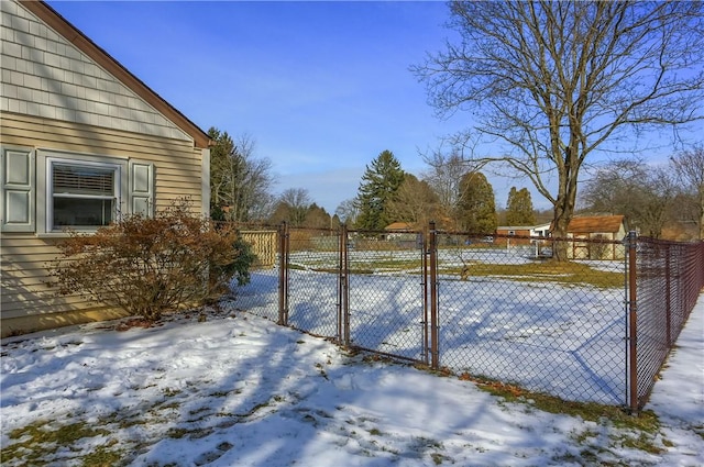 yard layered in snow with fence