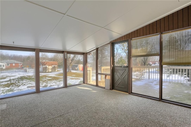 unfurnished sunroom with lofted ceiling and a wealth of natural light