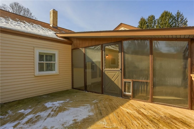 exterior space featuring a chimney and a wooden deck