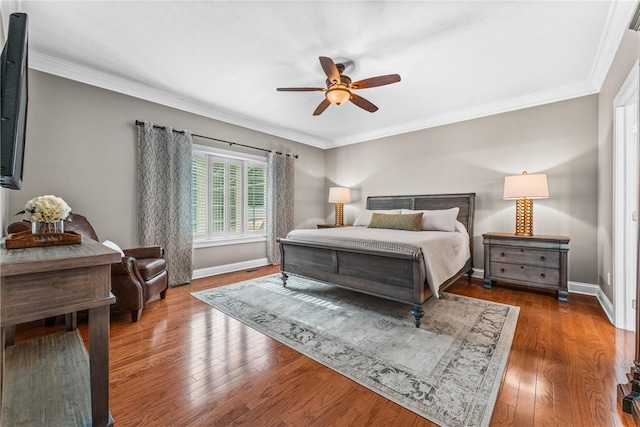 bedroom with crown molding, baseboards, and dark wood-style flooring