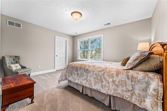 bedroom with carpet floors, visible vents, a textured ceiling, and baseboards