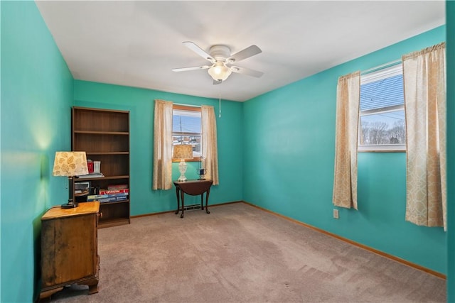 interior space featuring a ceiling fan and baseboards