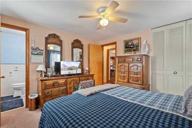 bedroom with a closet, carpet flooring, ceiling fan, and ensuite bathroom