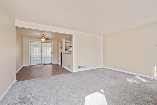 interior space with carpet, visible vents, and baseboards