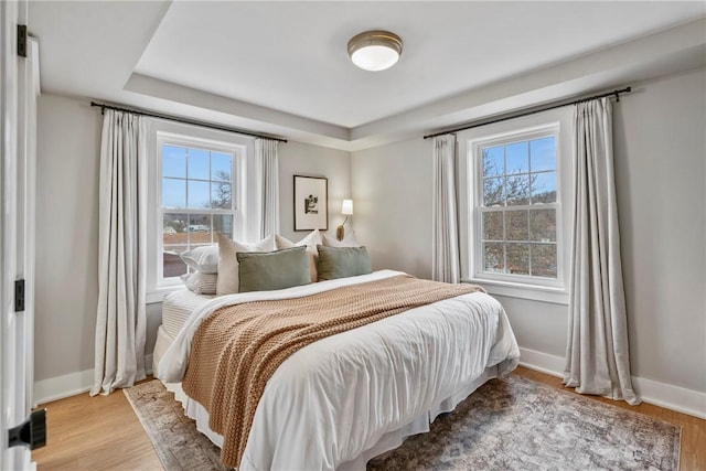 bedroom featuring wood finished floors and baseboards