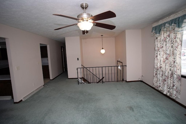 unfurnished room with baseboards, a textured ceiling, and carpet flooring