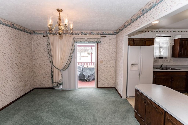 dining area featuring a textured ceiling, light colored carpet, baseboards, wallpapered walls, and an inviting chandelier