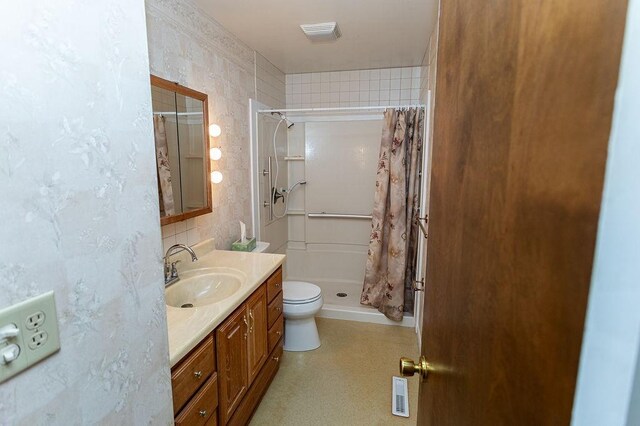 full bathroom with toilet, a shower stall, visible vents, and vanity