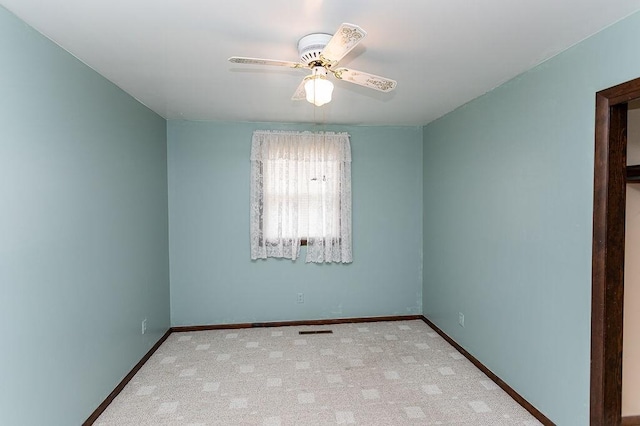 empty room with a ceiling fan, carpet, visible vents, and baseboards