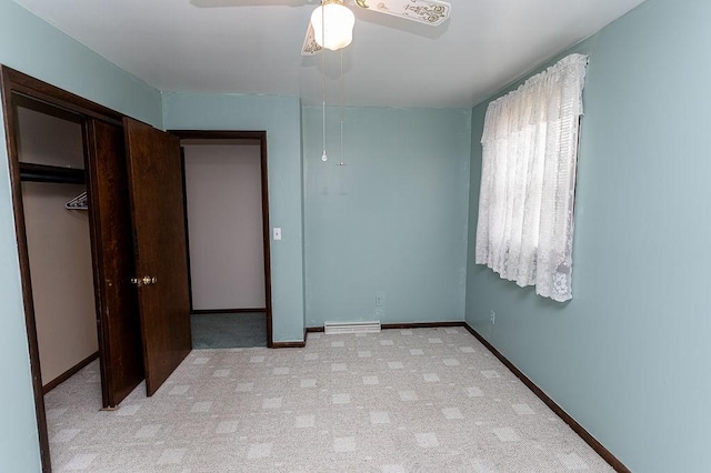 unfurnished bedroom with light carpet, ceiling fan, baseboards, and a closet