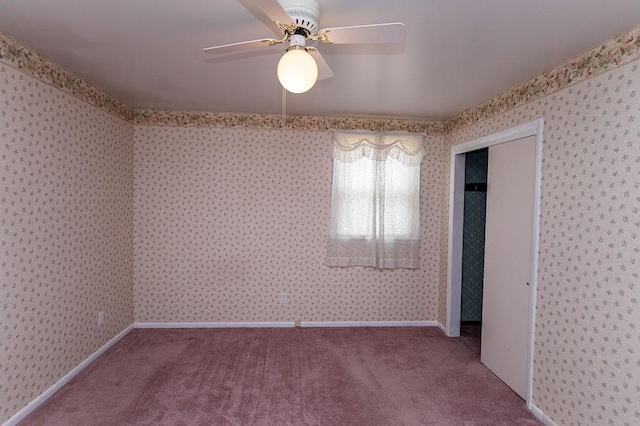 spare room featuring light colored carpet, baseboards, and wallpapered walls