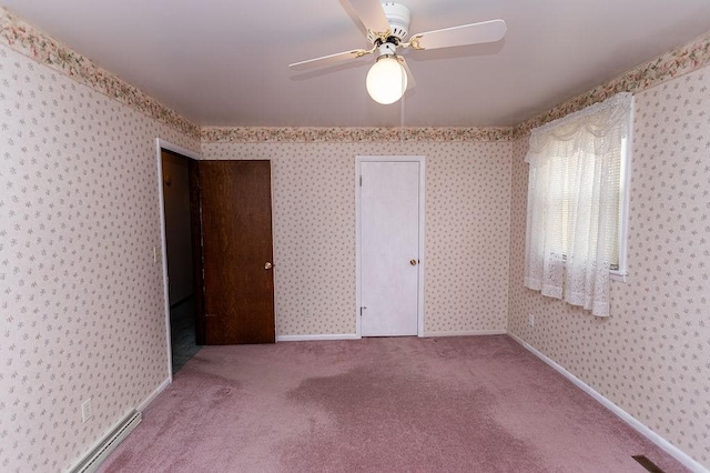 carpeted spare room with baseboards, a baseboard radiator, and wallpapered walls