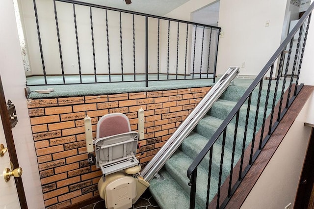 staircase with brick wall