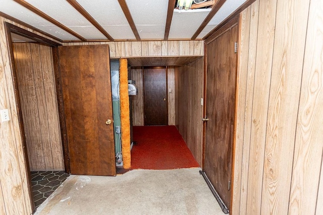 corridor featuring wooden walls