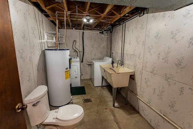 unfinished below grade area featuring washing machine and dryer and electric water heater