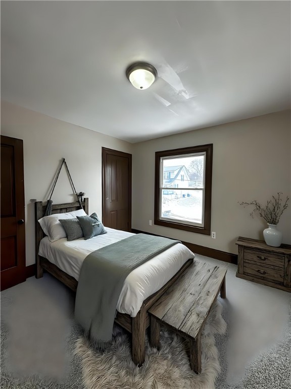 carpeted bedroom featuring baseboards