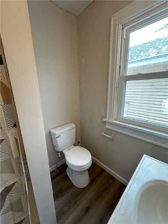 full bath featuring a sink, toilet, baseboards, and wood finished floors