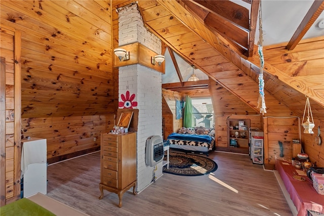 bedroom with dark wood-type flooring, vaulted ceiling, wood walls, and heating unit