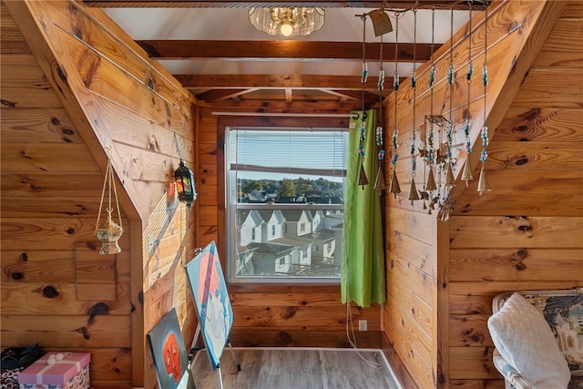 doorway with wood walls and wood finished floors