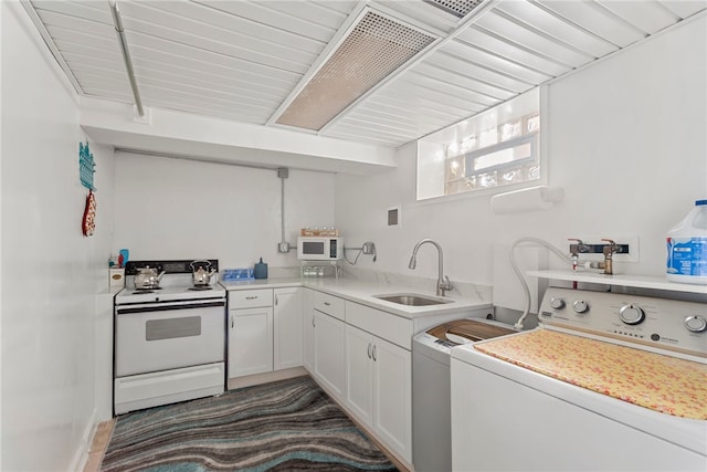 laundry room with laundry area, washing machine and clothes dryer, and a sink