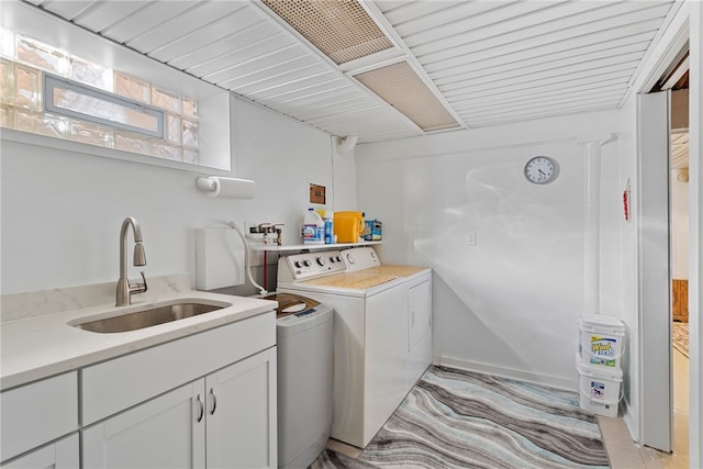 laundry room with cabinet space, a sink, and separate washer and dryer