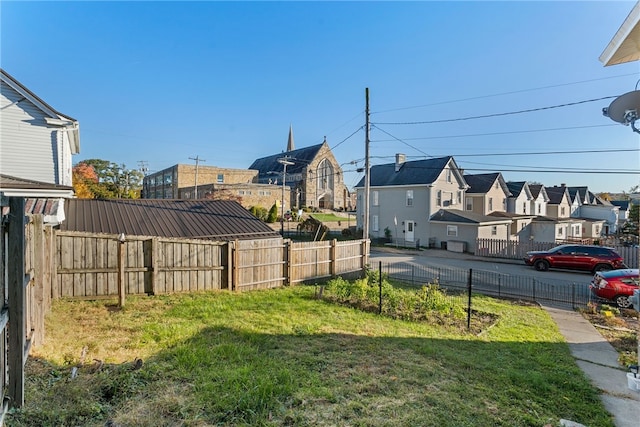 view of yard with fence and a residential view