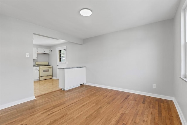 spare room with light wood finished floors and baseboards