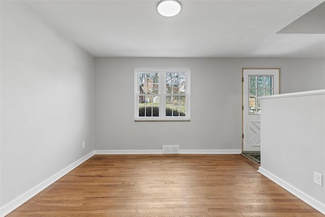 spare room featuring light wood-style flooring and baseboards