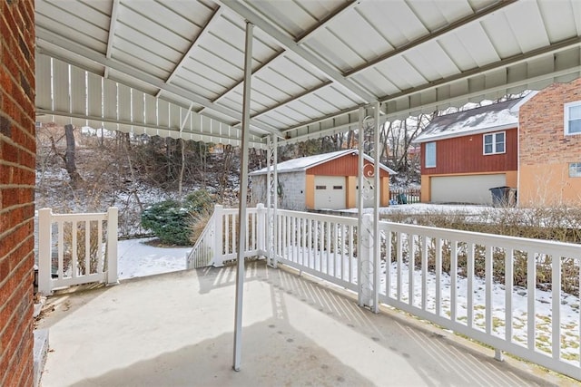 snow covered patio featuring an outdoor structure