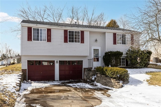 raised ranch featuring driveway and an attached garage