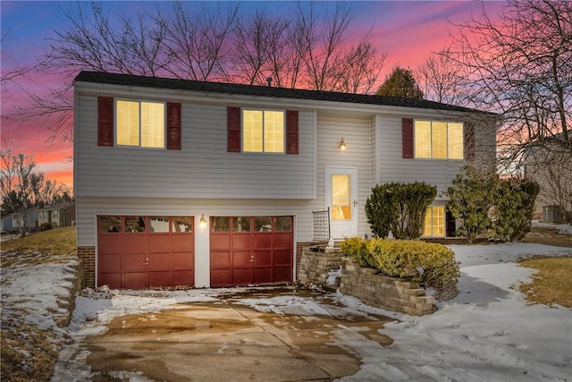 bi-level home featuring driveway and an attached garage