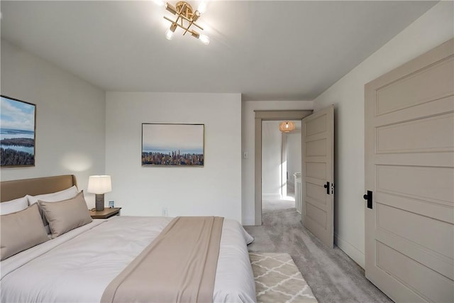 bedroom featuring light carpet and baseboards