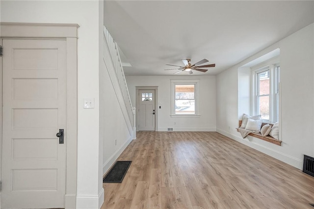 foyer with a ceiling fan, light wood-type flooring, visible vents, and baseboards