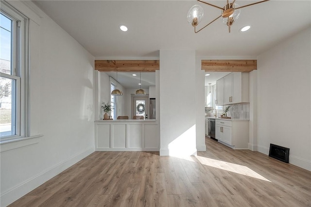 interior space with recessed lighting, visible vents, baseboards, light wood finished floors, and beamed ceiling