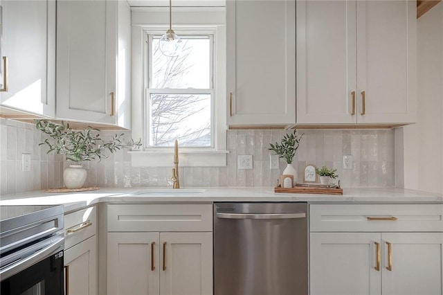 kitchen with a sink, light countertops, and dishwasher