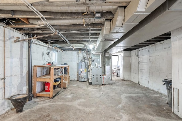 below grade area featuring gas water heater, visible vents, and heating unit