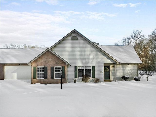 view of front of property featuring a garage and brick siding