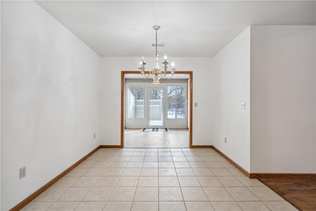 unfurnished room with a chandelier, visible vents, baseboards, and light tile patterned floors