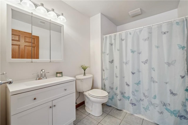 bathroom featuring toilet, curtained shower, tile patterned flooring, and vanity