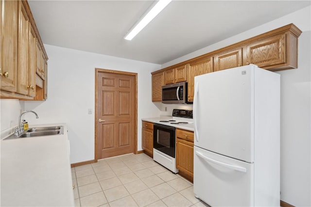 kitchen featuring white appliances, light countertops, a sink, and light tile patterned floors